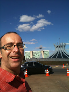 a man taking a selfie in front of a building