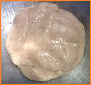 A big blob of ground chicken meat, blended with oil.  Flecks of pepper can be seen.