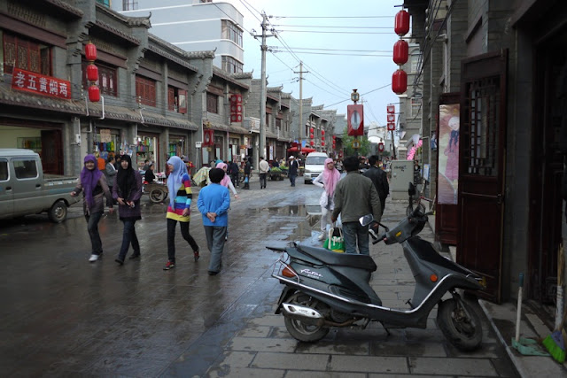 several Hui ladies walking down shopping street