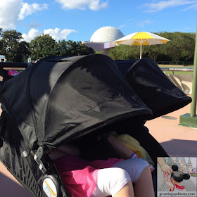 children napping in a stroller at Disney World