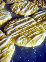 home-made cookies with white icing drizzled on top in zig zags