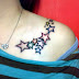Colorful star tattoos on shoulder
