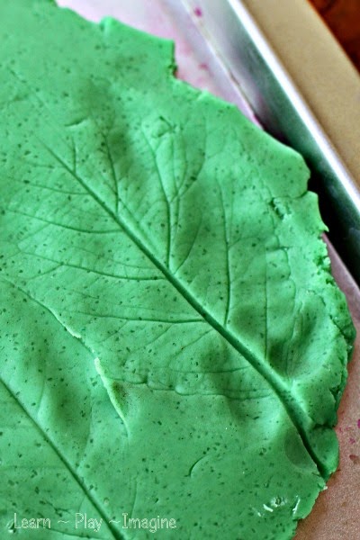 Making leaf prints in playdough