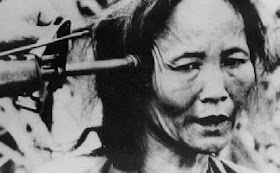 Holding a Vietnamese woman at gunpoint My Lai pointing gun elderly vietnamese woman