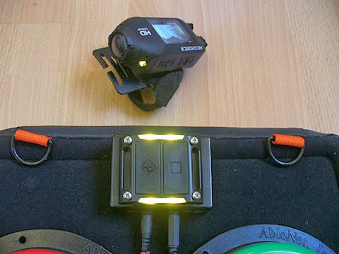 Switch adapted accessible video camera camcorder, the Drift Ghost HD with OneSwitch adapted blue-tooth handset, Trabasack and two Able-net switches.