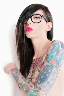 inked brunette girl in glasses