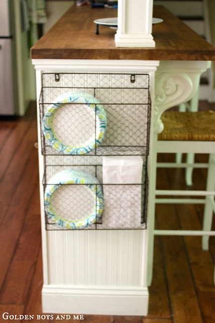 Wire basket for storage on side of kitchen island with bread board, part of Ikea Hack Kitchen Island via www.goldenboysandme.com