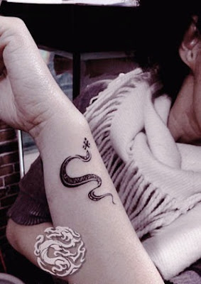 totem like snake tattoo on the arm