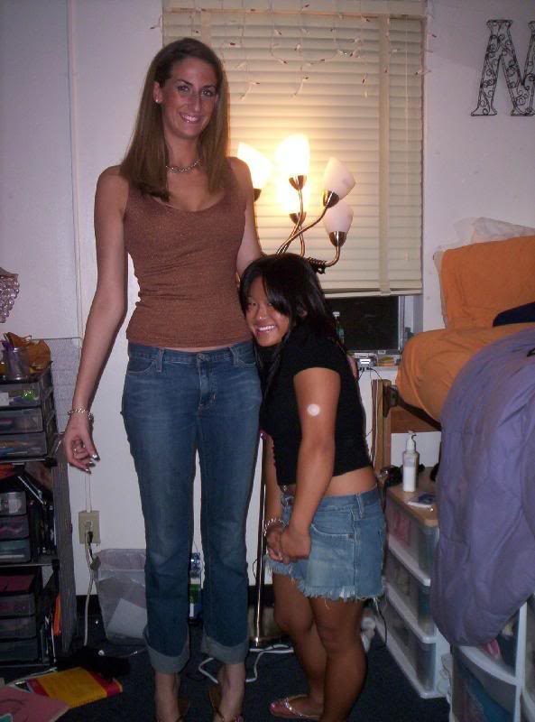 Tall girl compares heights with fan pic