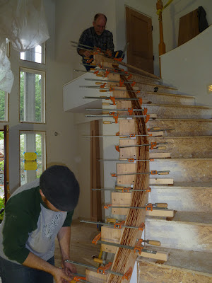 Christian Leach adds clamps to a custom built handrail in Juneau, Alaska built by Seattle Stair & Design