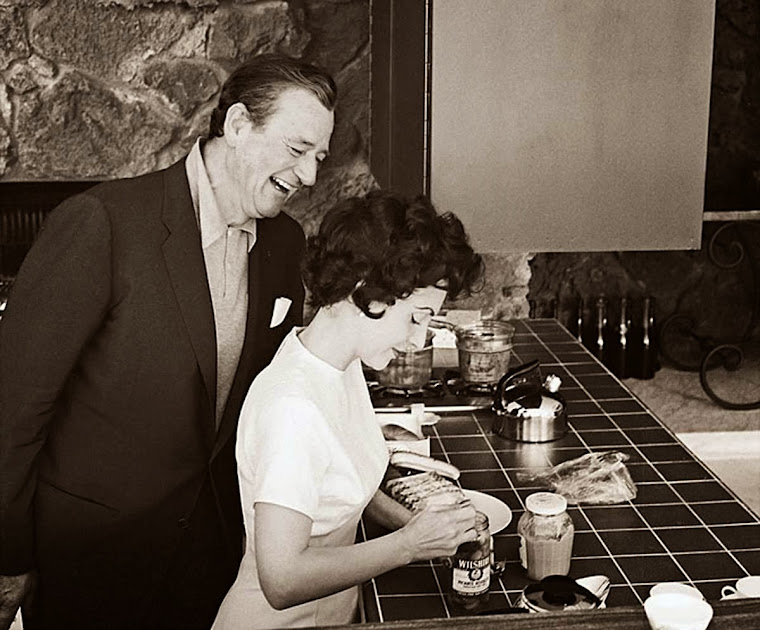 John and Pilar Wayne in the kitchen and bar area of the poolhouse