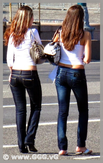The girls in blue jeans in the street