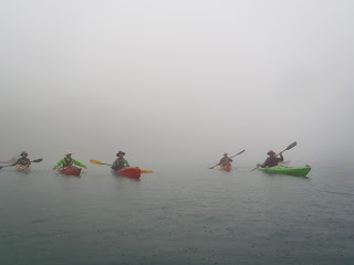 Kayaks emerge from the mist