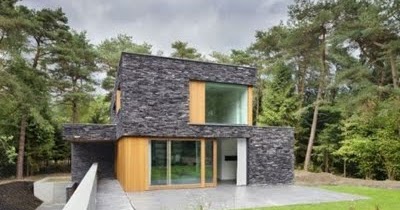 Revestimiento con piedra oscura en la fachada de la casa | decoracion