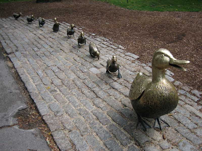 Brass mother duck and a line of ducklings behind her
