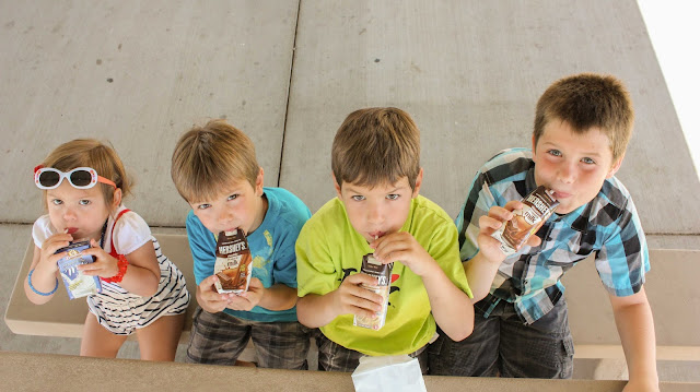 kids drinking their shelf stable milk at the park