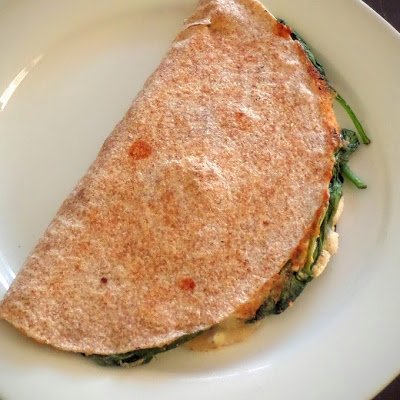 Spanakopita Quesadilla:  A fusion of Mexican and Greek cuisines.  Spinach, feta, and mozzarella packed into a whole wheat tortilla and fried.