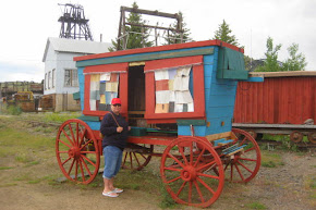 Nancy in front of old wagon