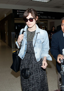 Keira Knightley with sunglasses and a black traveling bag