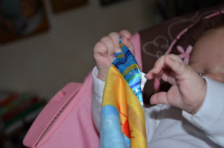 Baby hands Bright Starts Cuddle & Soothe Blanket.