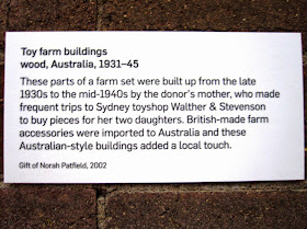 Museum exhibition explanatory sign for a display of vintage toy farm buildings from Sydney shop Walther & Stevenson.