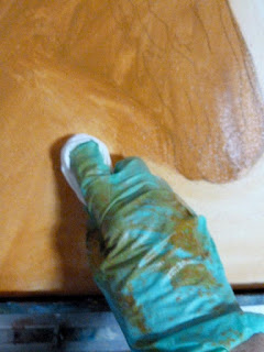Image of my gloved hand removing paint from the bottom layer of the Wickers the Warmblood Oil Painting.