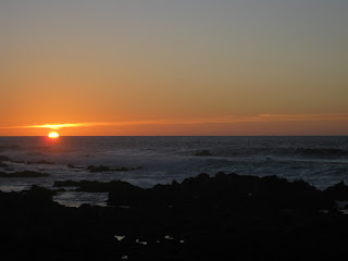 Sun dipping below the horizon at Point Pinos, Pacific Grove, California