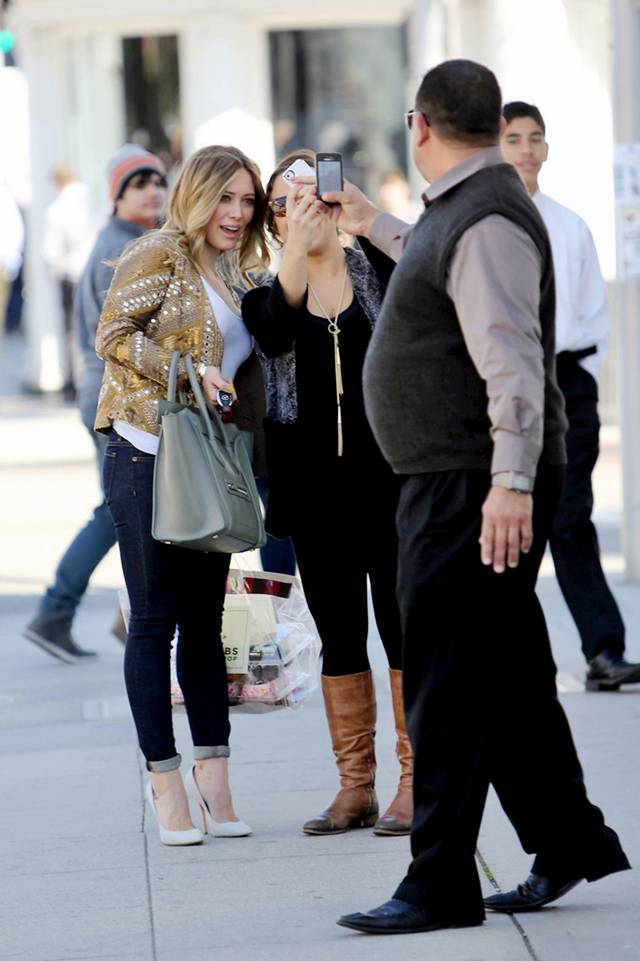 Hilary Duff shopped in Beverly Hills on Tuesday (February 12). The "Lizzie McGuire" star looked cute in a sparkling gold jacket, white top, and dark skinnies as she smiled at awaiting shutterbugs.