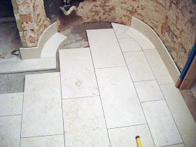 Floor under construction with curved skirting in Balzac limestone