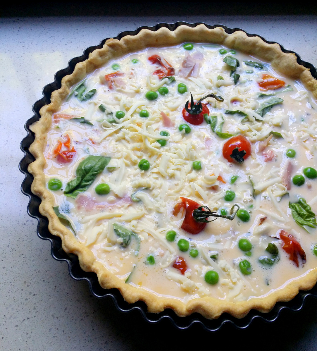 DeepDish Quiche with Blistered Tomatoes, Peas, Ham, Basil & Mozzarella
