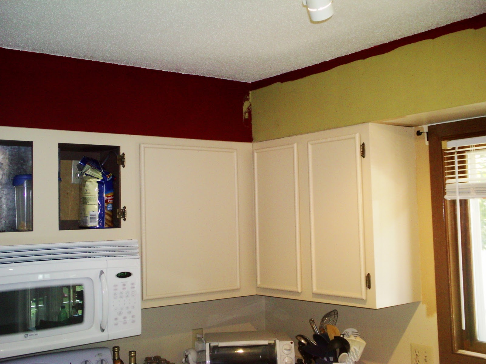 Olive green kitchen cabinets We also painted the walls an olive green.