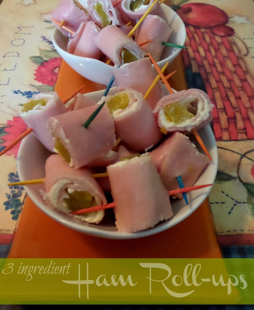 Party appetizers made with ham, pickles, and cream cheese with toothpicks