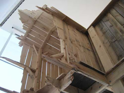 Upward show of Chris Larson's structure, showing ragged edges on the boards