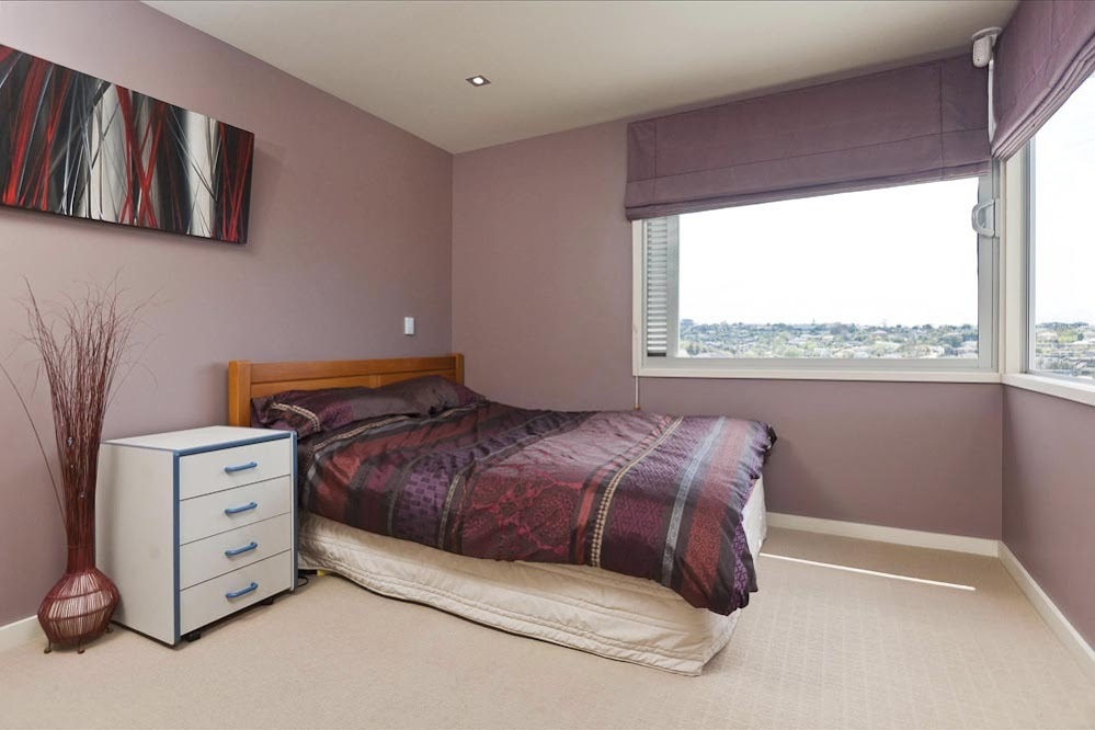 Photo of another bedroom with darker color and normal windows