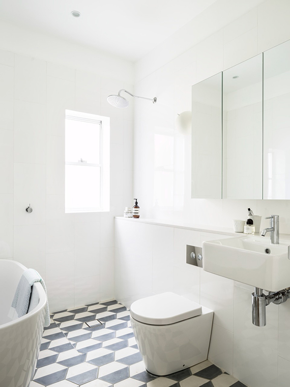 White bathrooms with b&w patterned floors | Decus Interiors