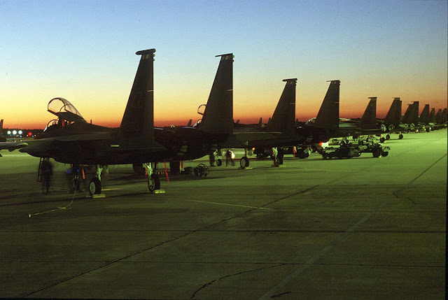A row of F-15s sits on the ramp.