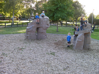 children on climbing rocks in park