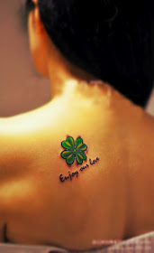 cute bright green four-leaf clover tattoo on the back
