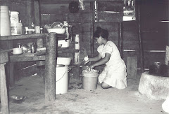 Terese grinds the corn for the day's tortillas