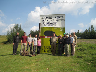 a group of people standing in front of a sign