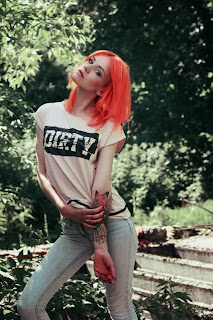 redhead showing tattoos outdoors 