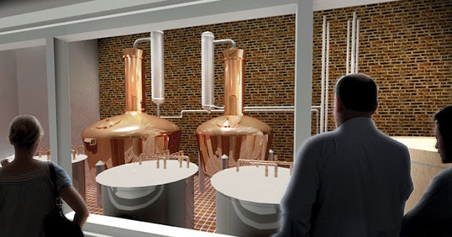 room with brick walls and two copper stills and guests on a tour in the foreground