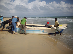 Pushing a fibreglass boat into the sea for carting a chinese V.I.P delegation to "Pigeon Island".