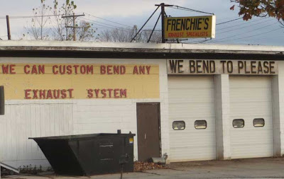 Muffler shop with sign that says We Bend to Please