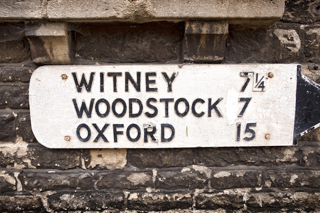 Oxford, Witney & Woodstock on an old street sign in Charlbury