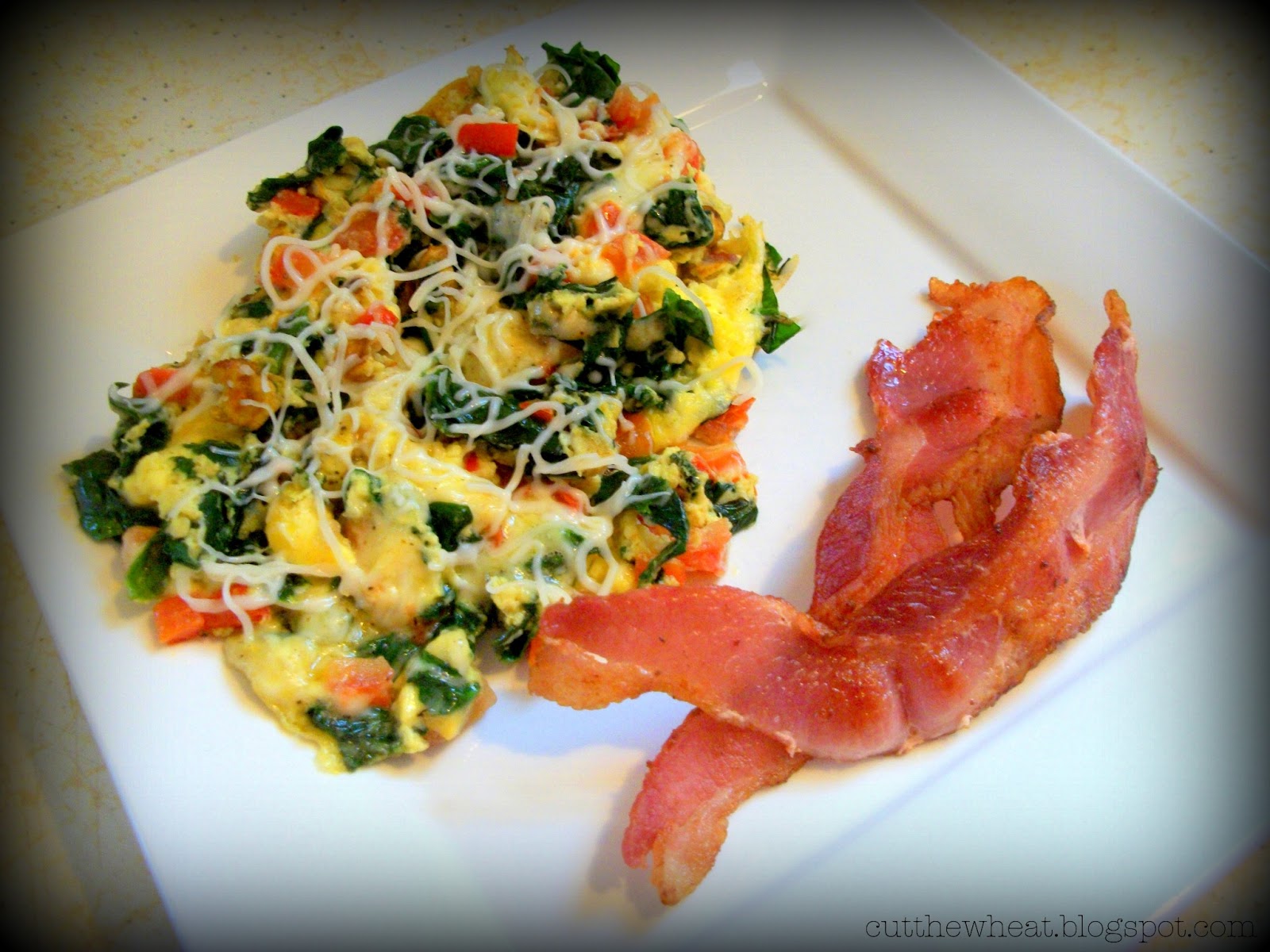 Garlic Eggs Florentine with Tomatoes, Red Peppers and Mozzarella Cut