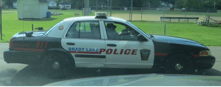 A Brady Lake Village cop on his phone while driving in BLV on Lakeview Dr.