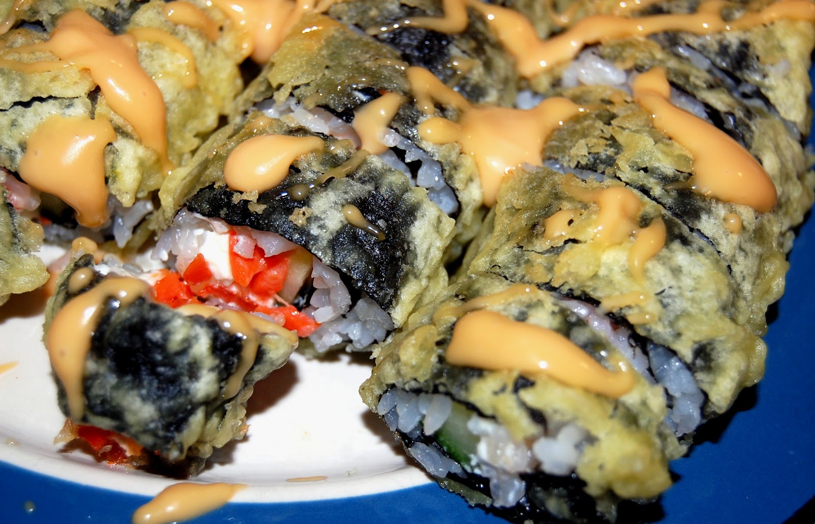 One Bite at a Time Deep Fried Sushi Drizzled with Spicy Sauce