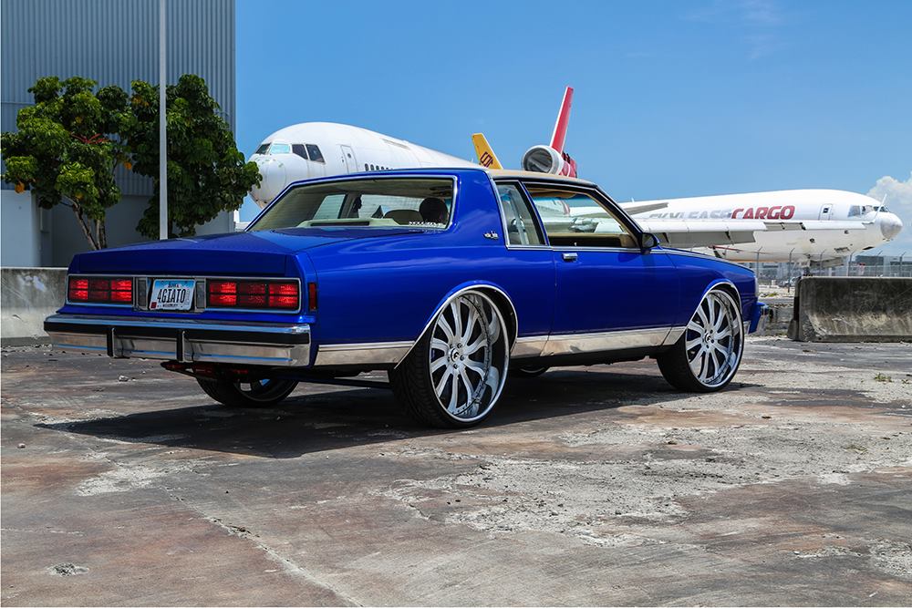 1989 blue Chevrolet Caprice (Box Chevy) rides on chrome