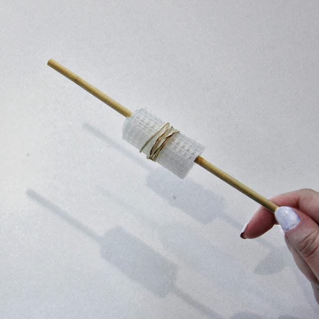 grid plastic canvas bracelet on chopstick